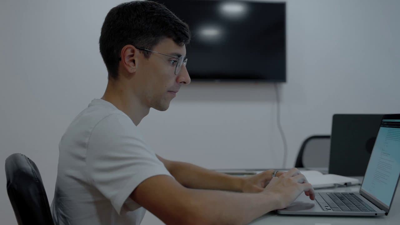 A focused professional reviewing work on a laptop before an interview.